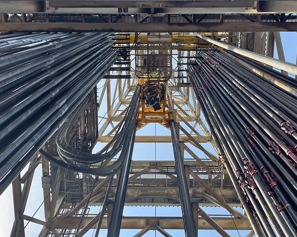 Top drive system (TDS) is a motorized unit suspended from the derrick to rotate the drill string, revolutionizing drilling by enabling faster, safer operations by replacing the traditional rotary table and Kelly system.